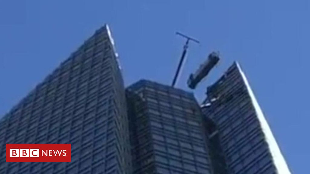 Window cleaners rescued from swinging lift