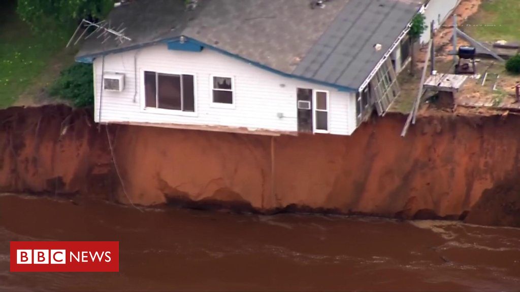 Homes hanging over river bank in US