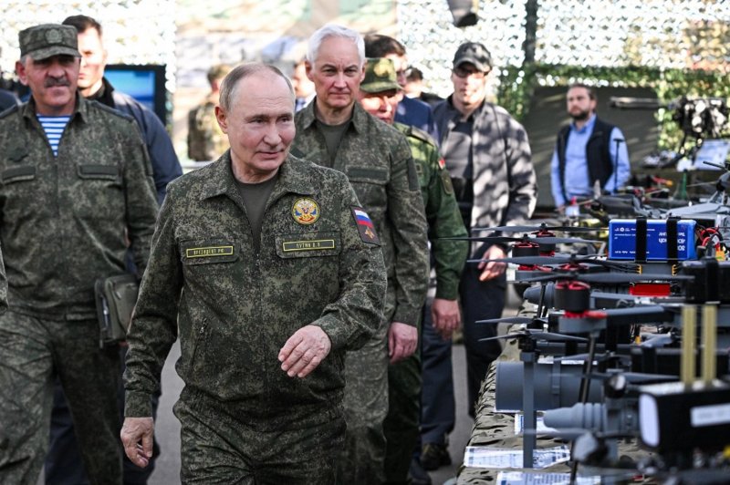 Putin dons military uniform...
