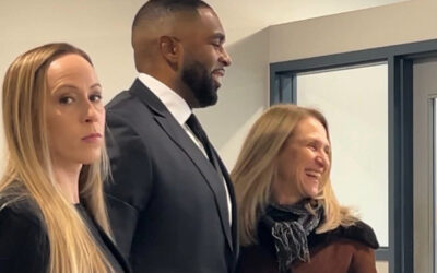 Disgraced Michigan coach Sherrone Moore yuks it up in court as wife Kelli stares daggers after cheating scandal