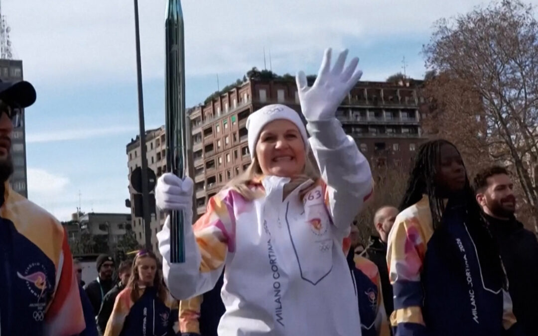 Olympic torch travels through central Milan hours before games