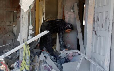 Palestinians in Gaza search through homes destroyed by Israeli strikes